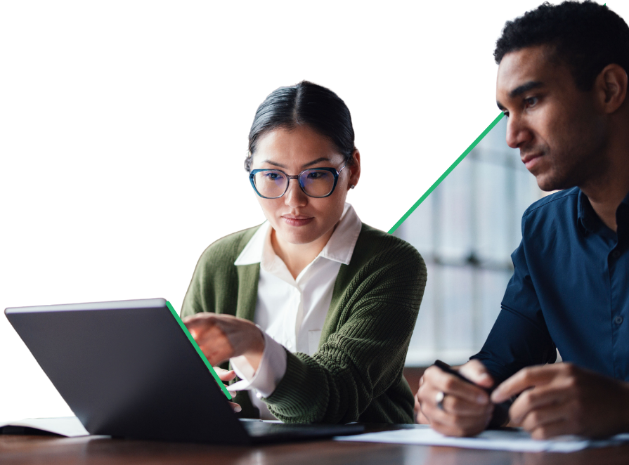 Two colleagues collaborating on a project, looking at the laptop screen.