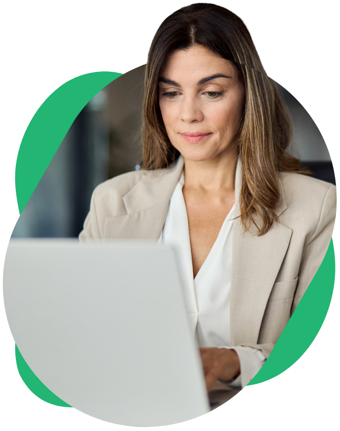 Professional working on a laptop at a desk.