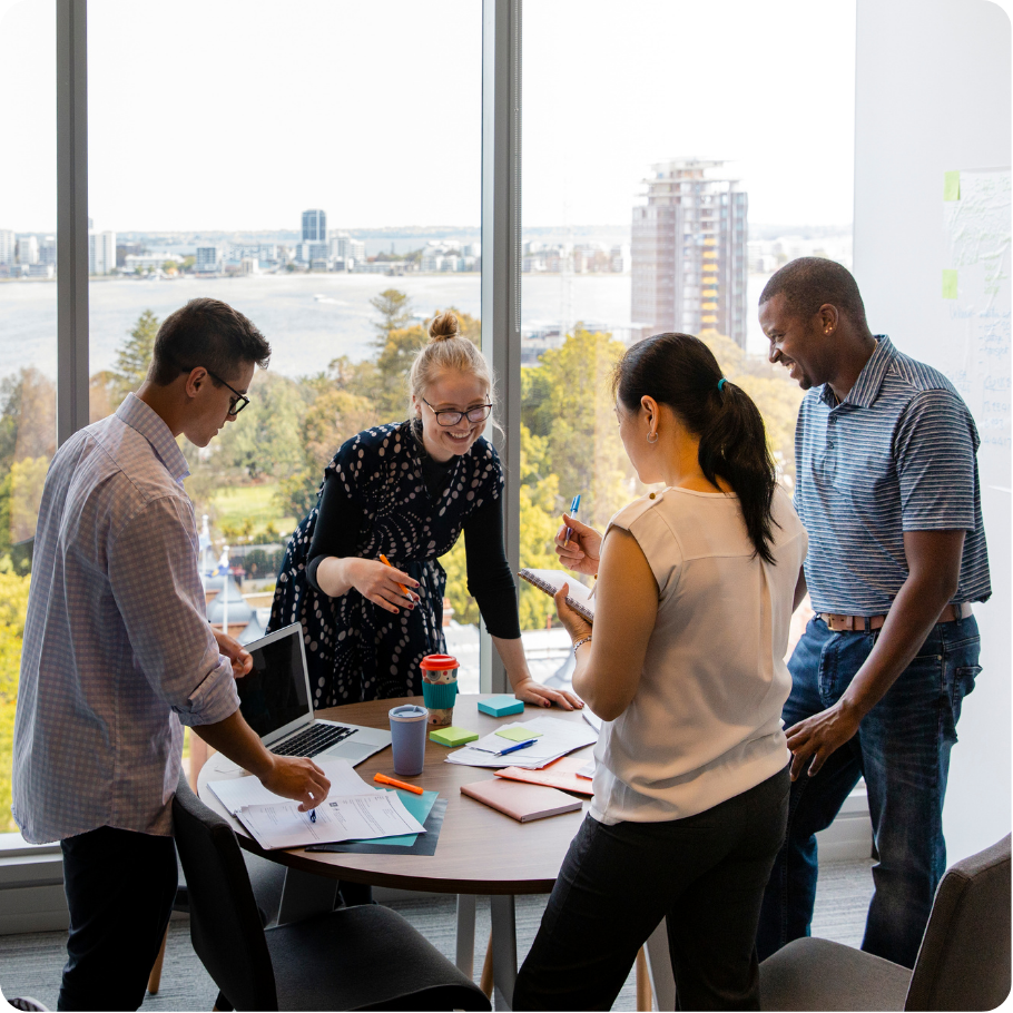 Group of professionals standing together in a workplace setting.