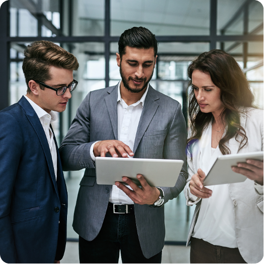 Group of professionals standing together in a workplace setting.