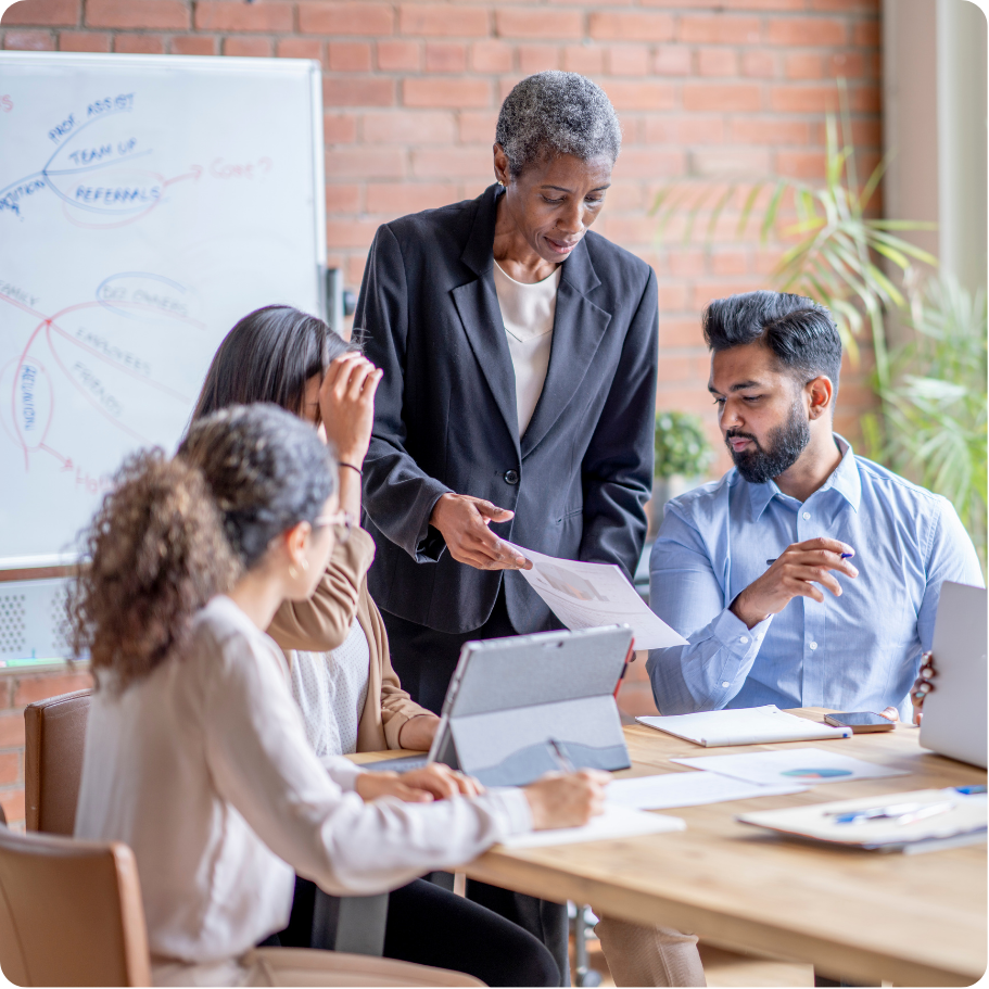 Group of professionals standing together in a workplace setting.