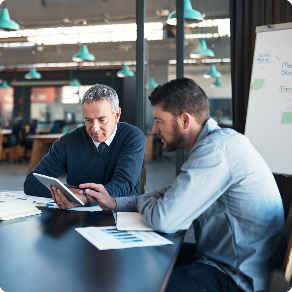 Two colleagues collaborating on a project in an office setting.
