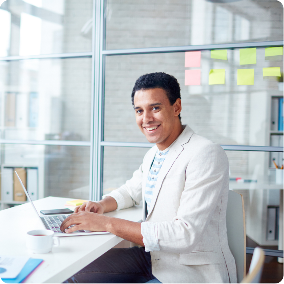 Professional working on a laptop at a desk.