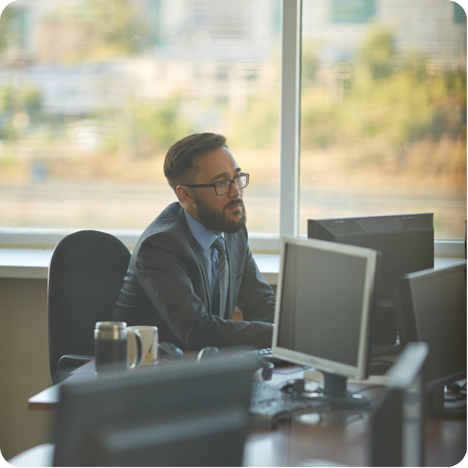 Professional working on a computer at a desk.