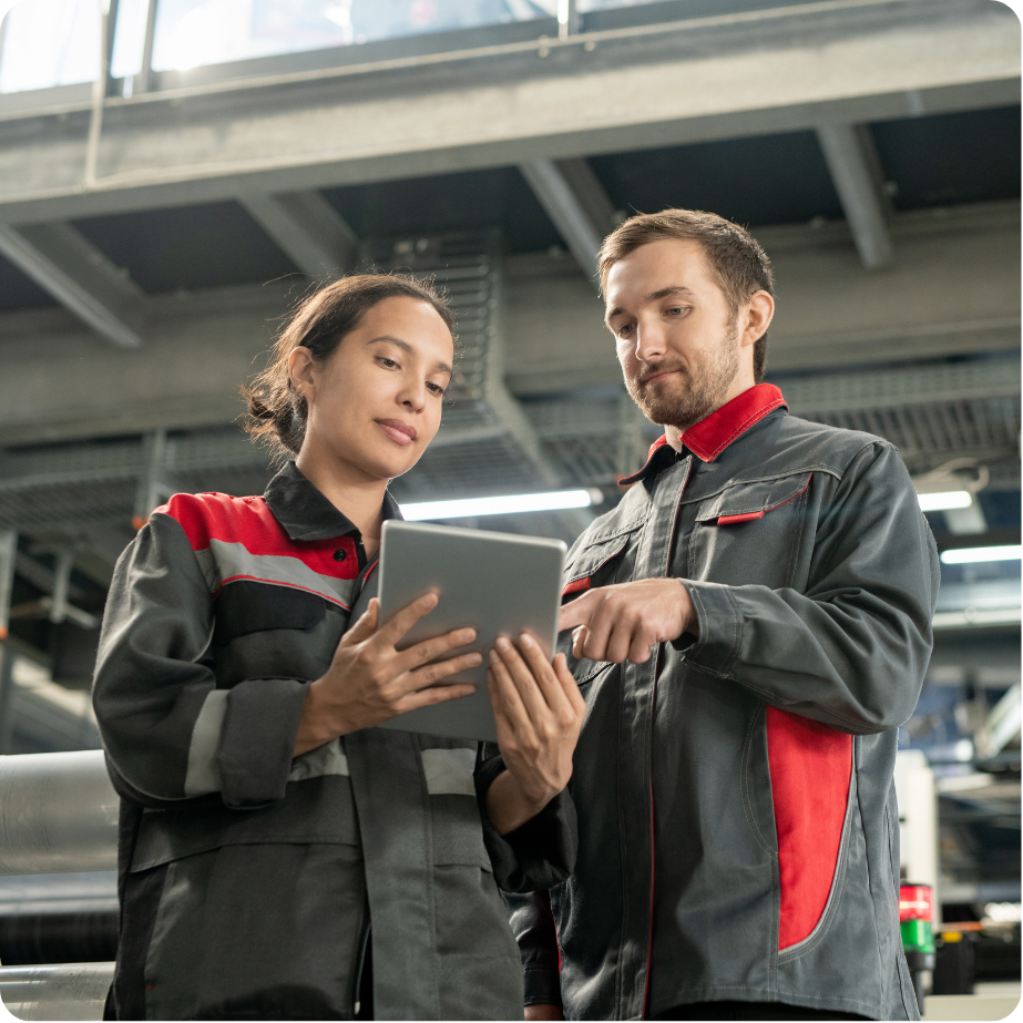 Two colleagues walking looking at tablet screen.
