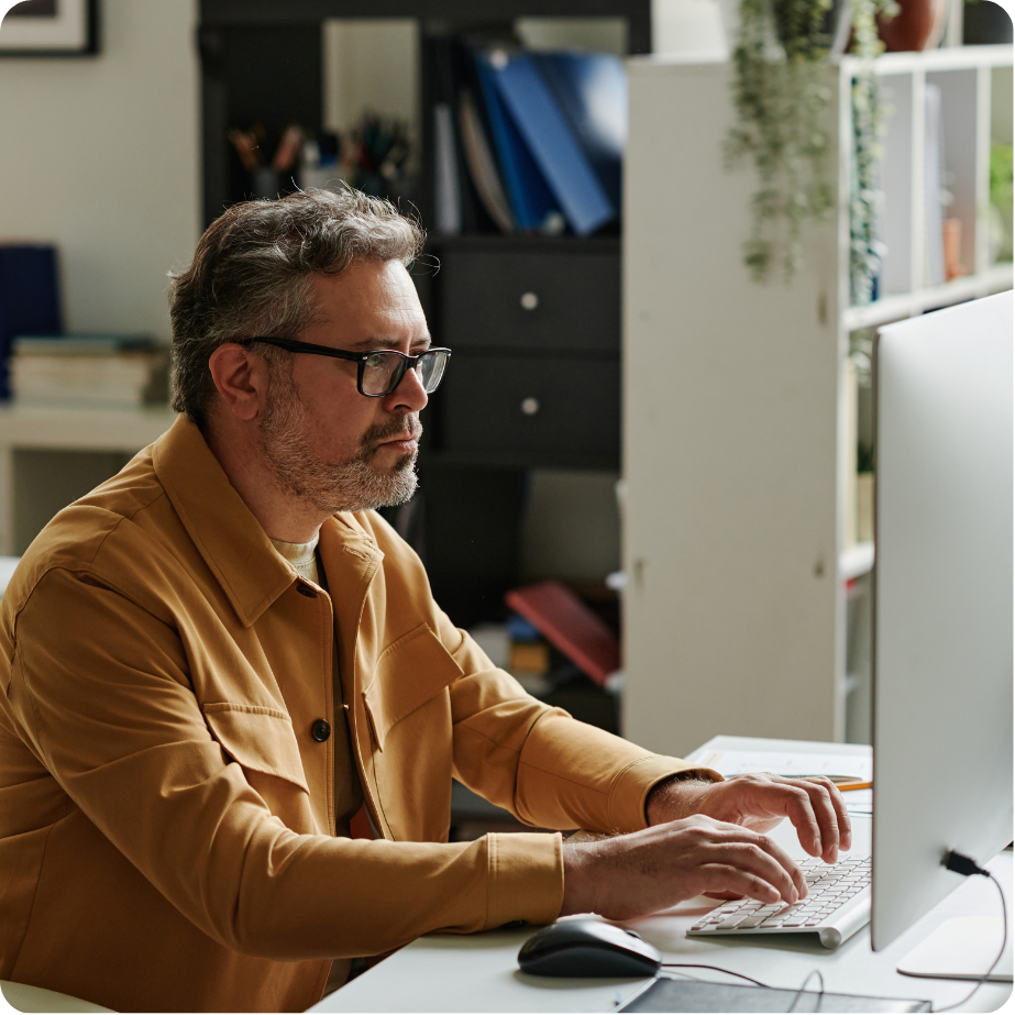 Professional working on a computer at a desk.